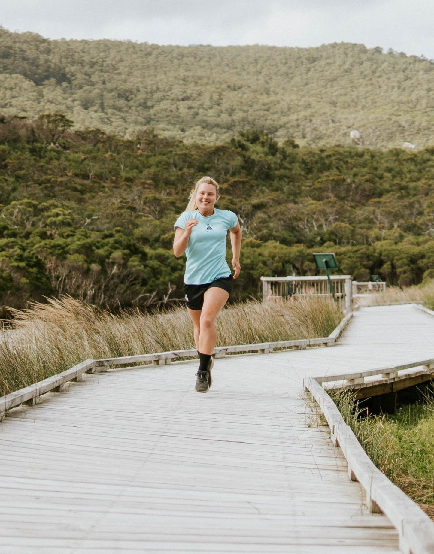 Women's running top in teal with moisture wicking technology made from recycled material. Shirt is eco friendly using only recycled material made in Australia.