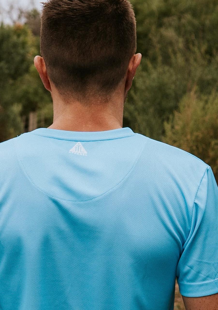 Sky blue running and training top. Back view with TTL logo. Made from recycled material. Made in Australia.