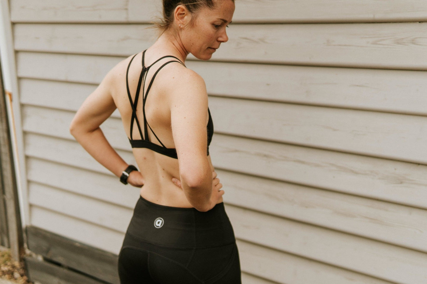 Medium support sports bra in black with breathable mesh. Picture of back with supporting crisscross straps.