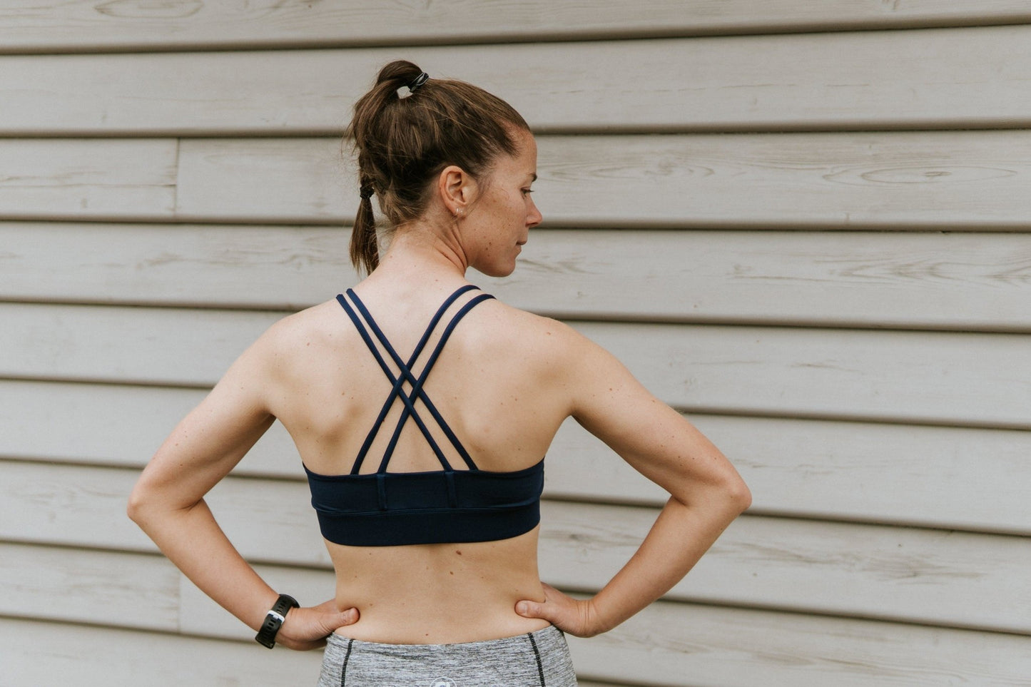 Back of medium support sports bra in black.