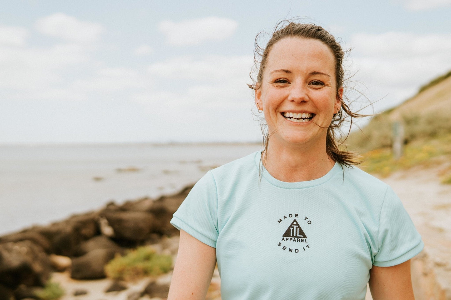 Women's running top in sky blue and teal. Made in Australia from recycled material. Highly breathable material that is light weight and wicks away moisture.