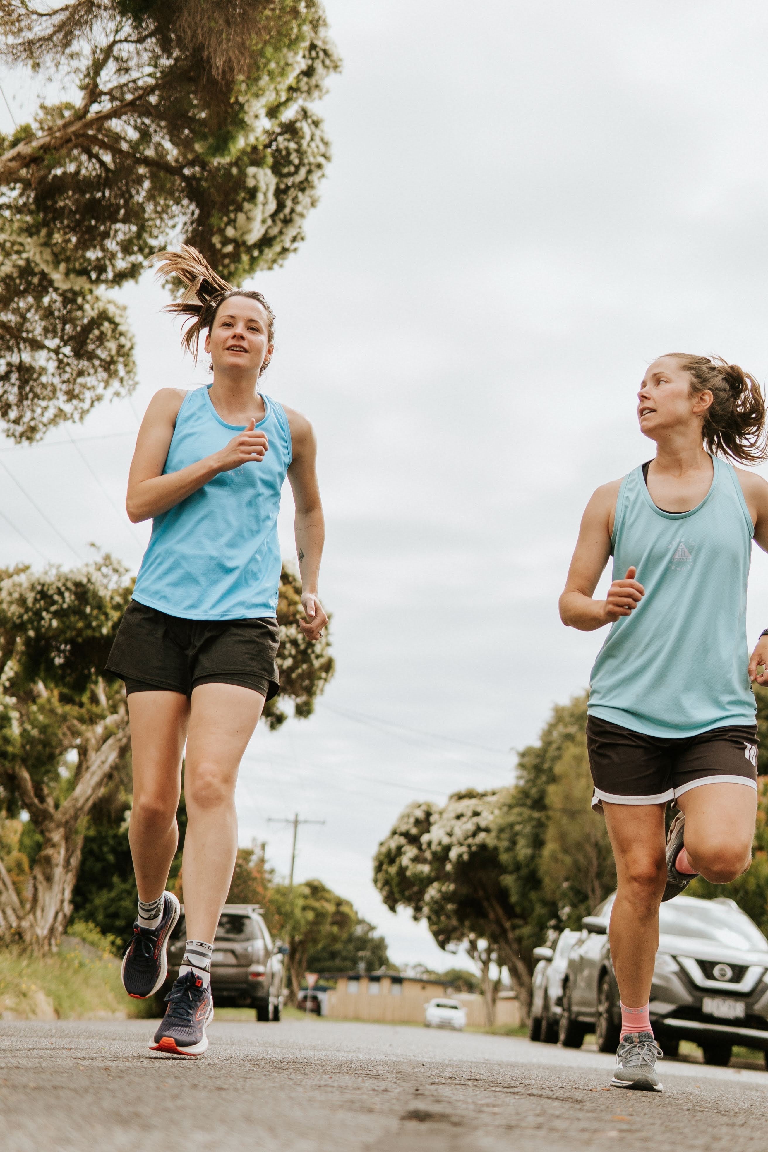 Women's running singlet in both sky blue and teal. These training and running singlets are made in Australia from recycled materials. 